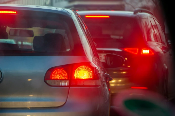a group of cars driving down a street next to each other