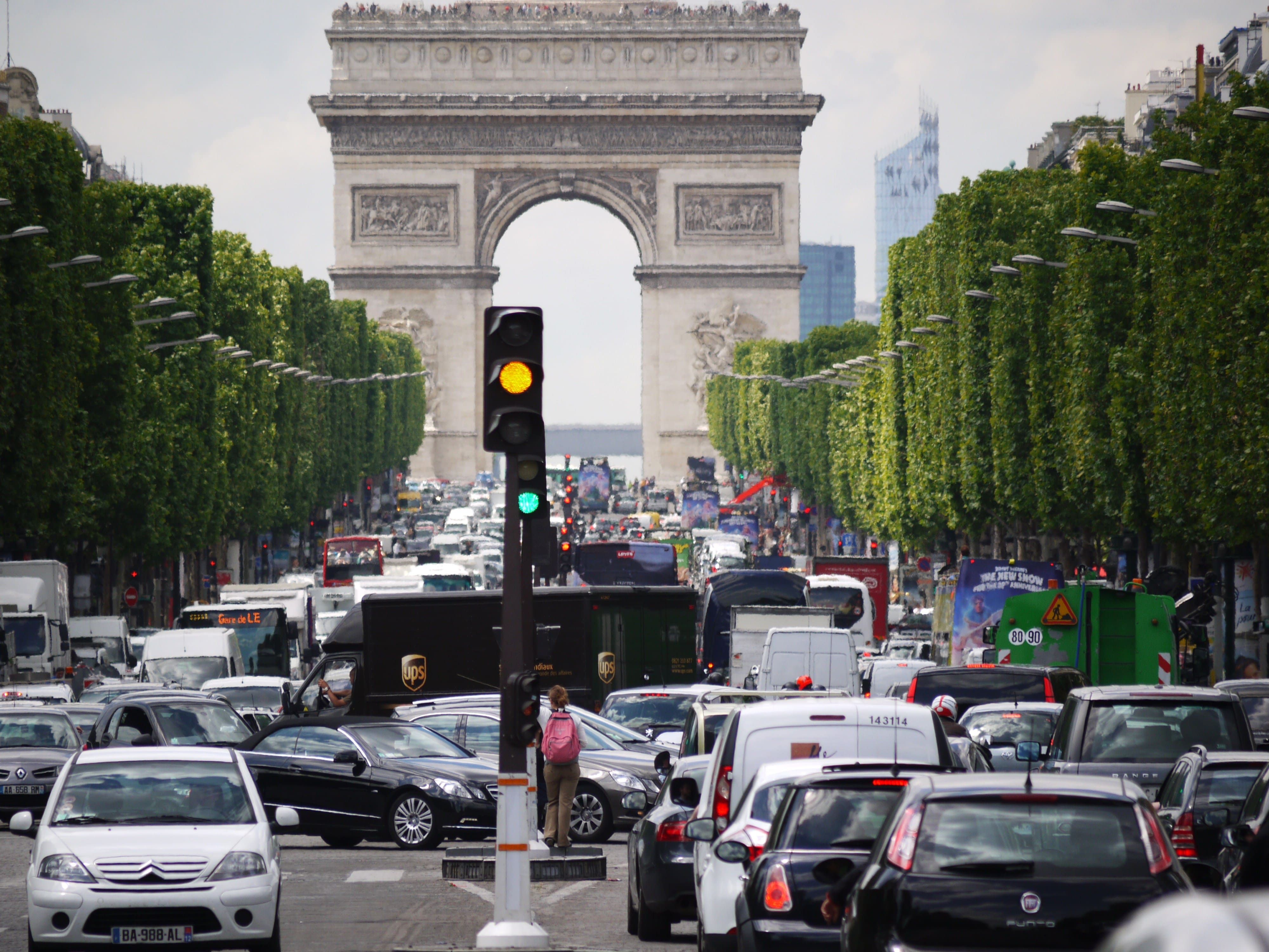 Congestion Congestion in front of the Arc de Triomphe in Paris, France. A traffic light is orange