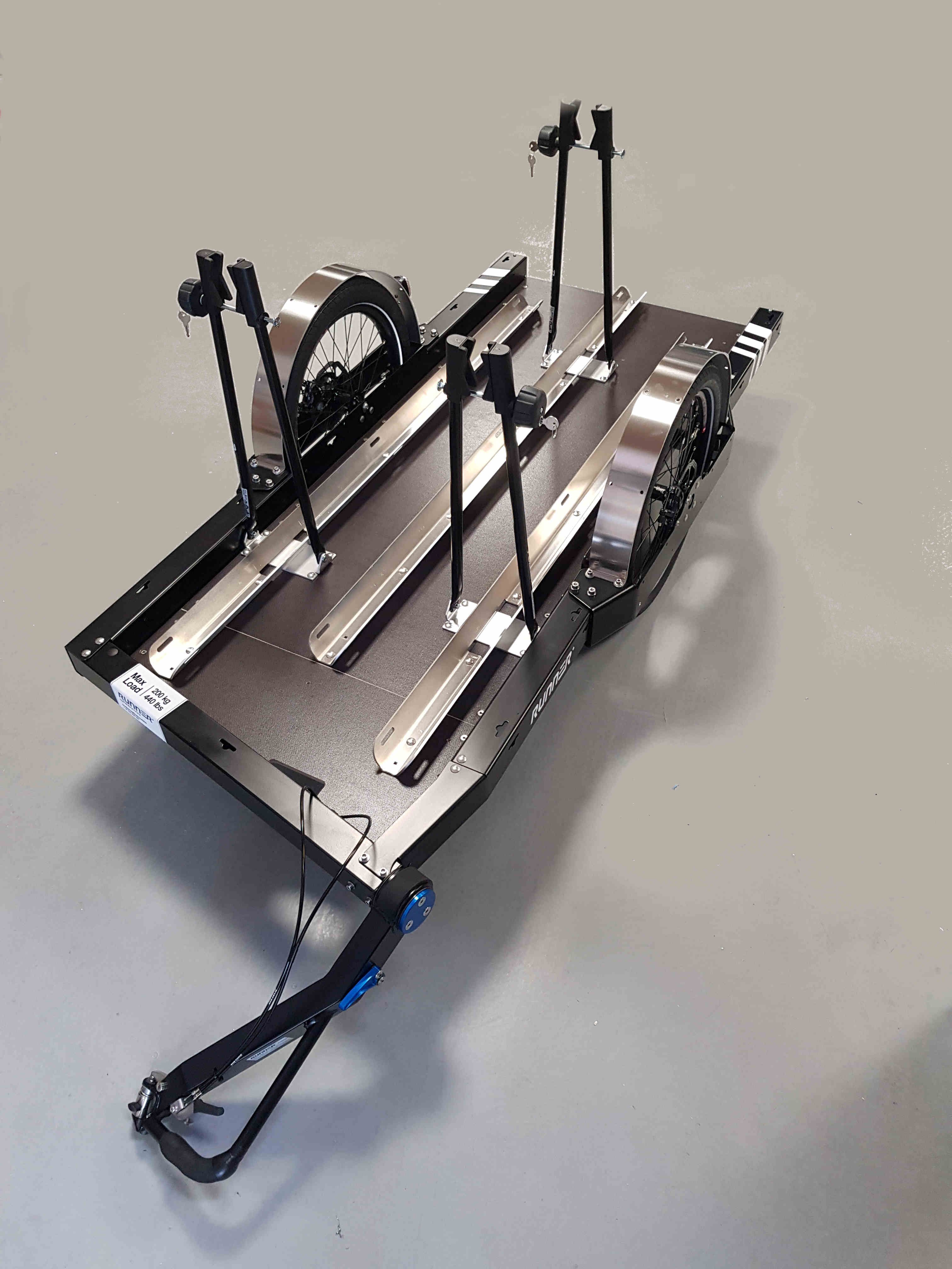 Bike transport Black bike trailer with three rails and clamps to fix bikes on it