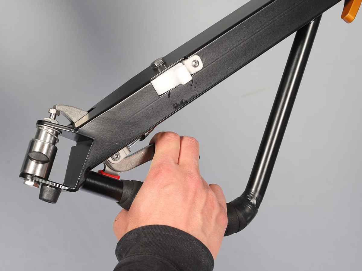 Hand activating a lever and brake of the XL BicyLift bike trailer