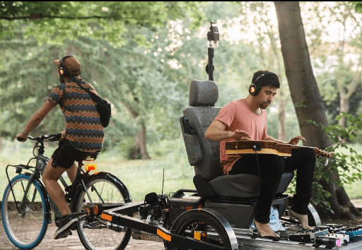 Guitar player carried on a bike trailer