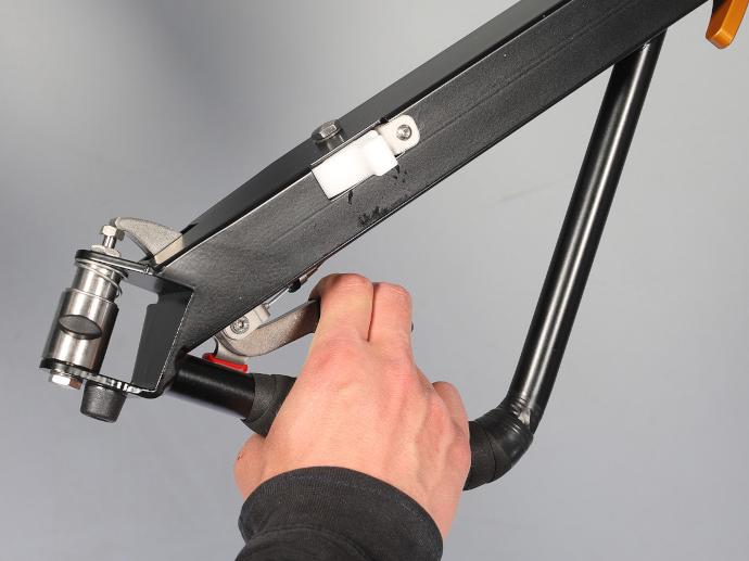 Hand on the drawbar of a bike trailer that activates the brake