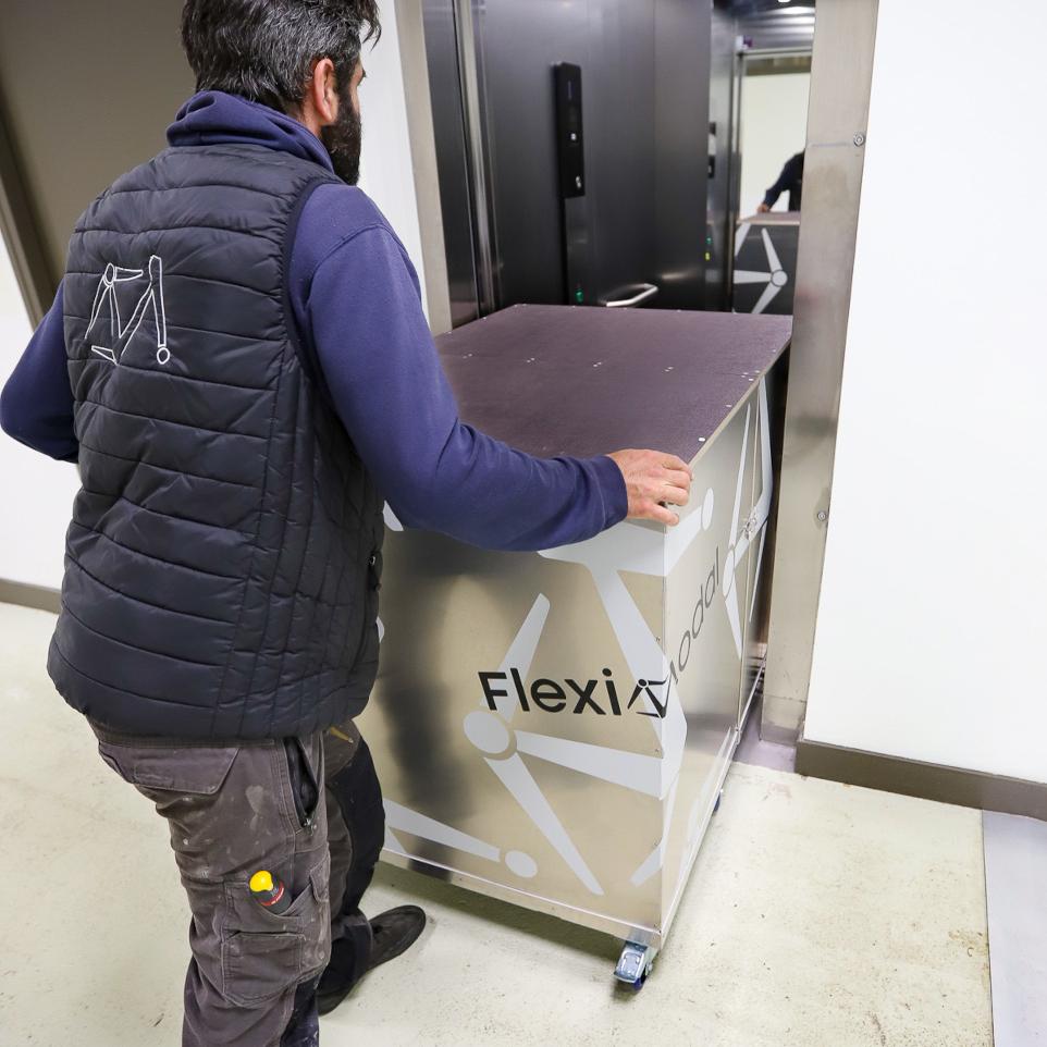 Person pushing the WorkBox in an elevator