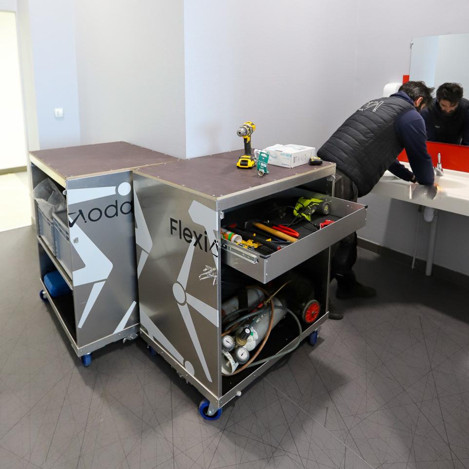 Plumber using an aliminum container with his tools to fix an issue
