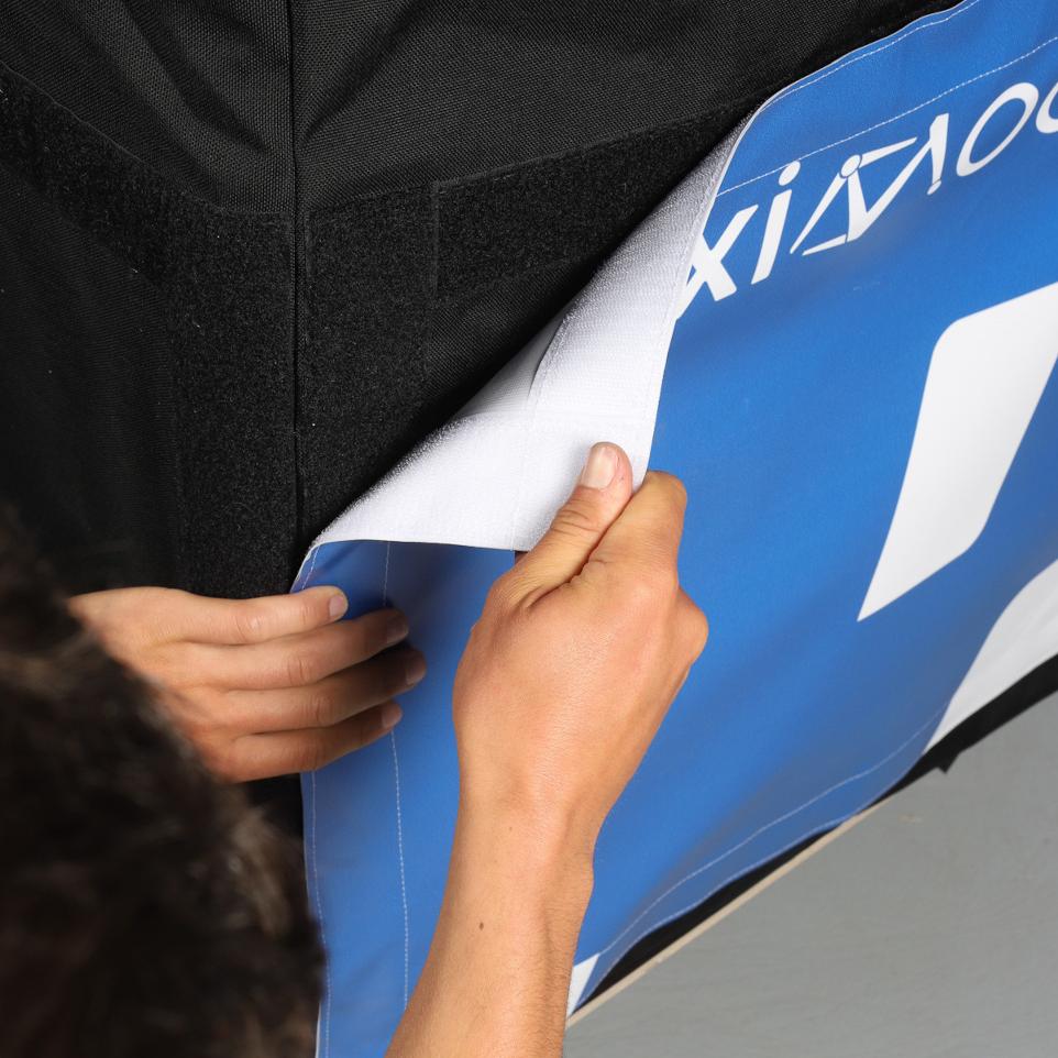 Blue and white tarp being removed from a black tissue