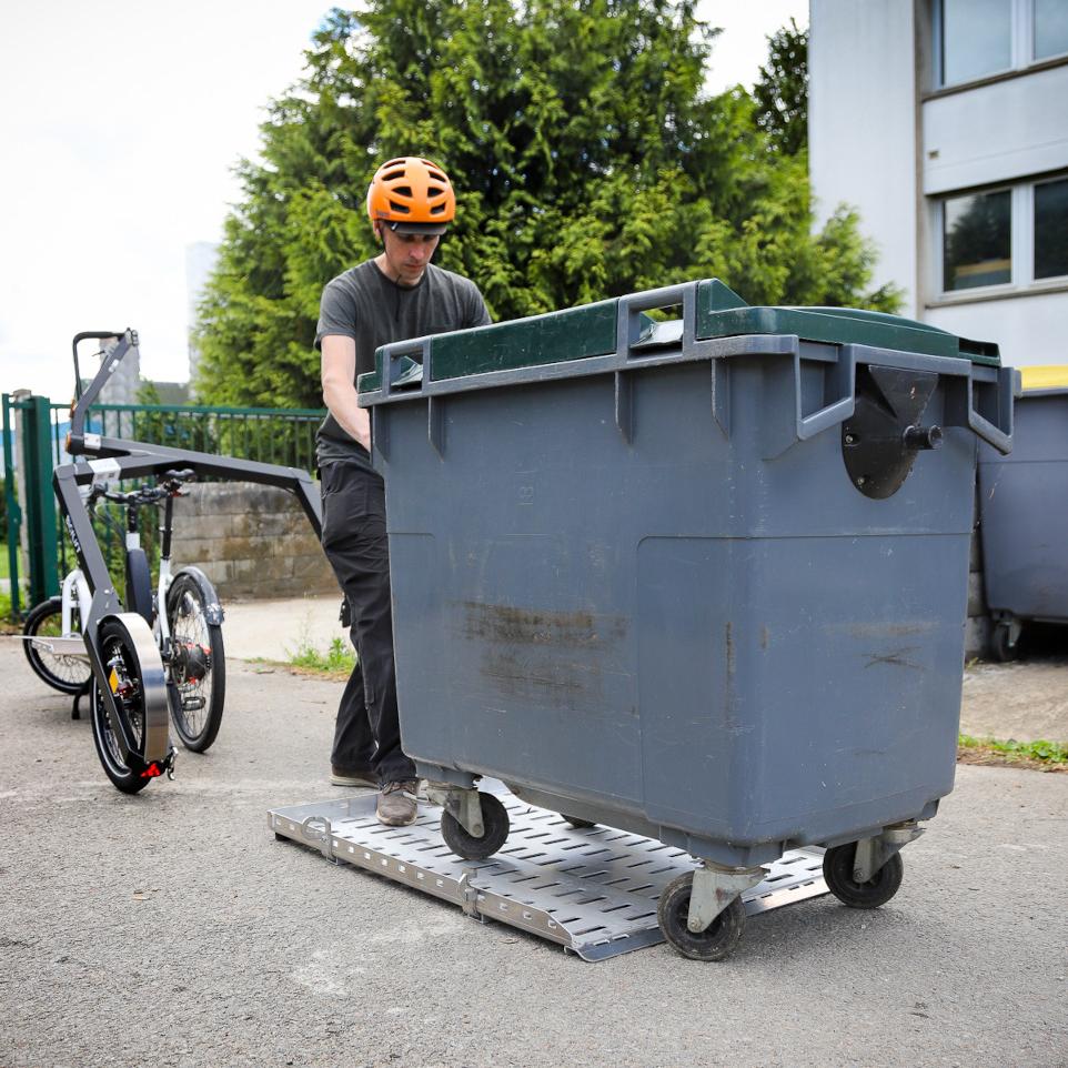 A bin being pushed on a flatbed