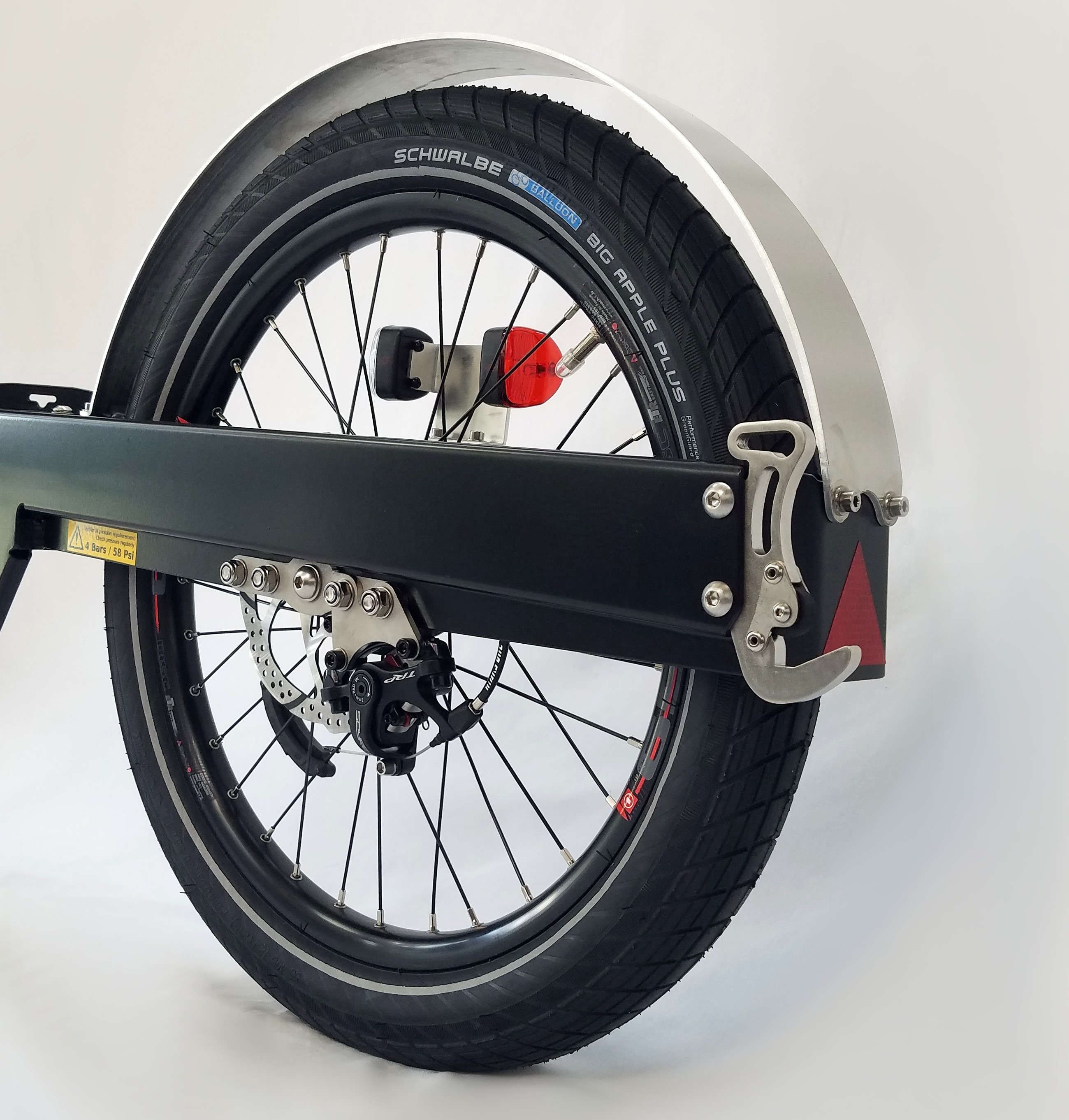 Part of a bike trailer with wheel, disc brake, hook, mudguard and a red and white light